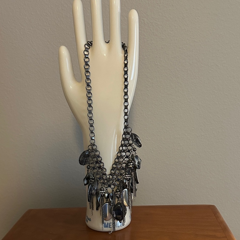Costume jewelry. Large necklace with lots of layered chains and baubles.